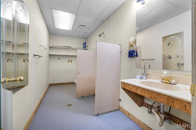 Bathroom featuring finished concrete floors and a drop ceiling | Image 35