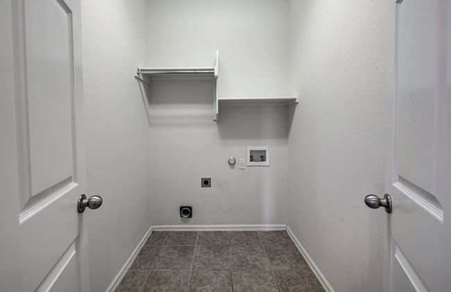 Laundry area featuring hookup for an electric dryer, washer hookup, baseboards, gas dryer hookup, and laundry area | Image 16