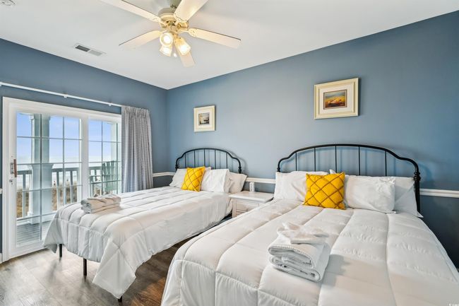 Bedroom featuring access to outside, wood finished floors, and a ceiling fan | Image 13