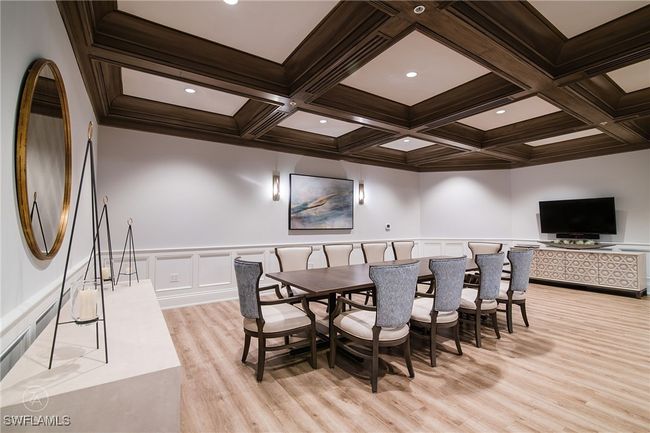 Dining area featuring light wood-type flooring, crown molding, coffered ceiling, and beamed ceiling | Image 33