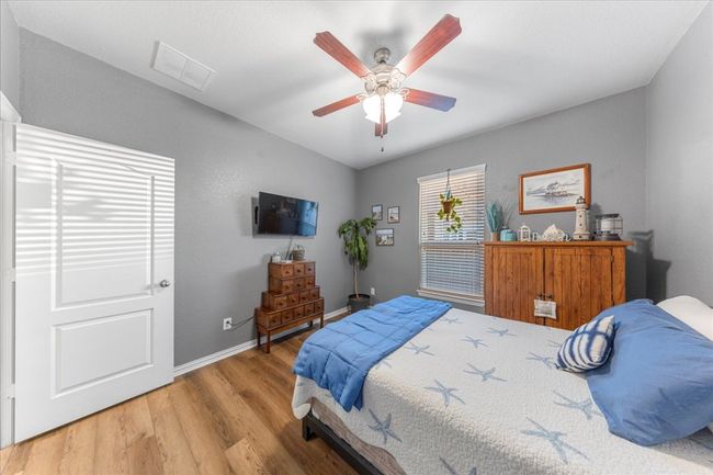 Bedroom featuring wood finished floors and a ceiling fan | Image 14