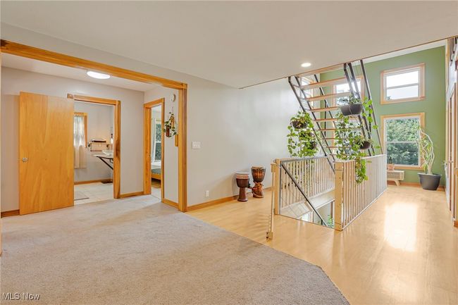 Corridor featuring an upstairs landing, recessed lighting, wood finished floors, and carpet flooring | Image 6