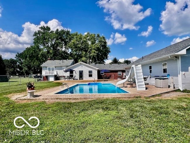 view of pool featuring a water slide and a patio | Image 67