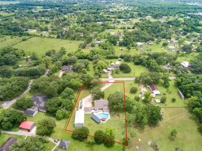 Tucked away on 1.5 serene acres in Manvel, this distinctive property is built for the way you want to live. The flexible floorpan allows between 4 to 6 bedrooms, 2.5 baths, a 2-car garage, in-ground pool, plus a 60'x30' insulated shop. | Image 49