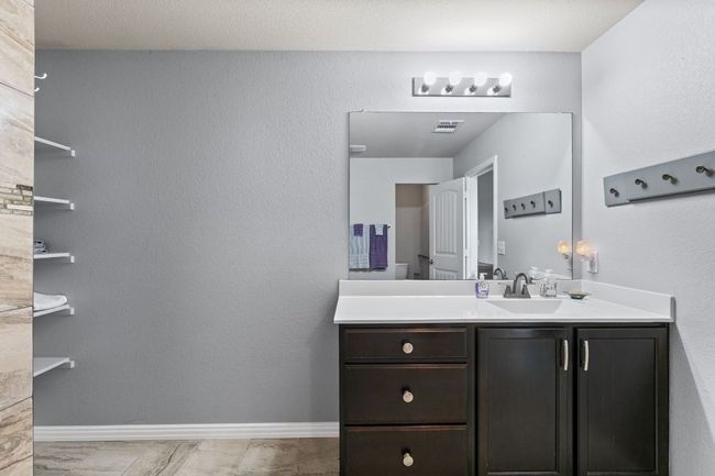 Bathroom with visible vents, vanity, and baseboards | Image 8