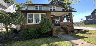 View of front facade with a front lawn | Image 1