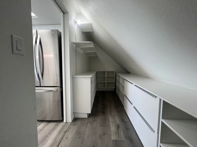 Additional living space featuring wood finished floors and lofted ceiling | Image 15
