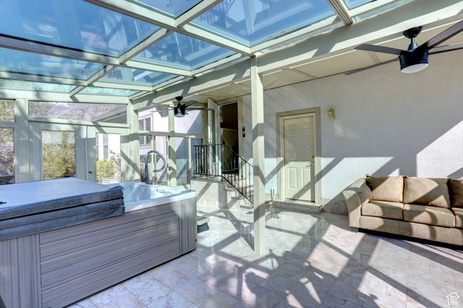 Sunroom / solarium featuring a hot tub | Image 28