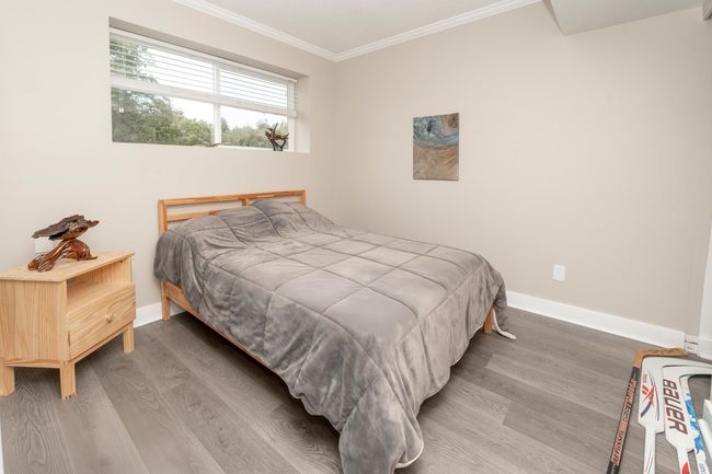 Bedroom with wood finished floors, baseboards, and ornamental molding | Image 21