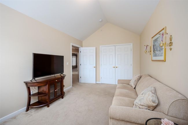 Living room featuring vaulted ceiling and light colored carpet | Image 21