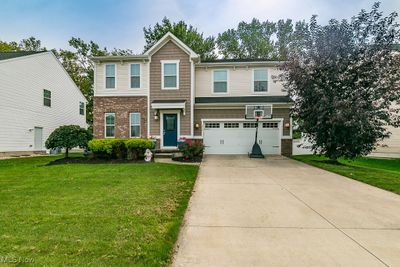 View of front of home with a front yard and a garage | Image 1