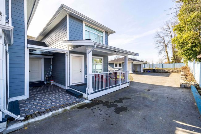 View of property exterior featuring an outbuilding, covered porch, and fence | Image 27