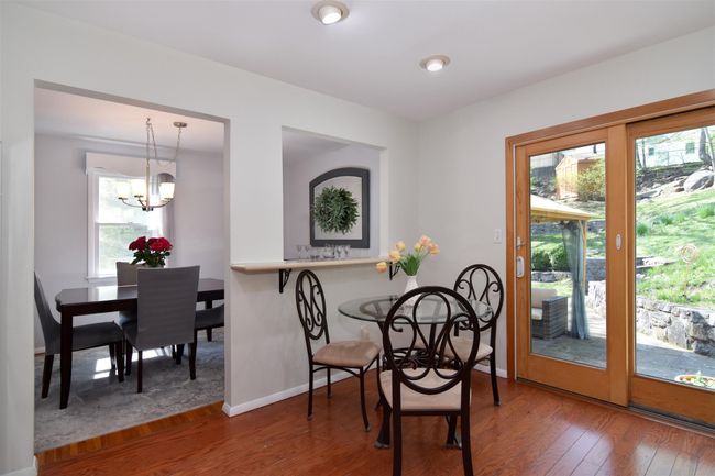 Dining space featuring baseboards, wood finished floors, and a chandelier | Image 6