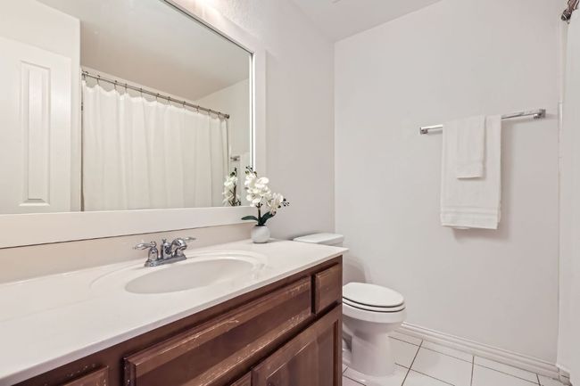 Full bathroom with vanity, tile patterned floors, and toilet | Image 18