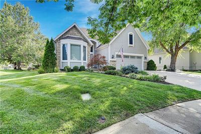 View of front of home featuring a front yard and a garage | Image 2