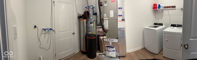 laundry room featuring baseboards, wood finished floors, independent washer and dryer, and laundry area | Image 15