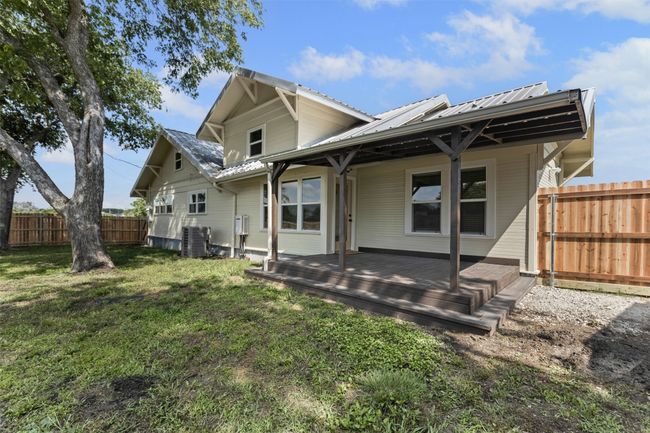 Back of house featuring metal roof, central air condition unit, and a wooden deck | Image 36