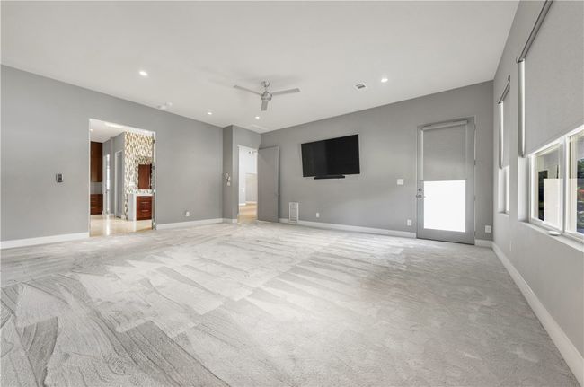 Unfurnished living room featuring light carpet, ceiling fan, and recessed lighting | Image 20