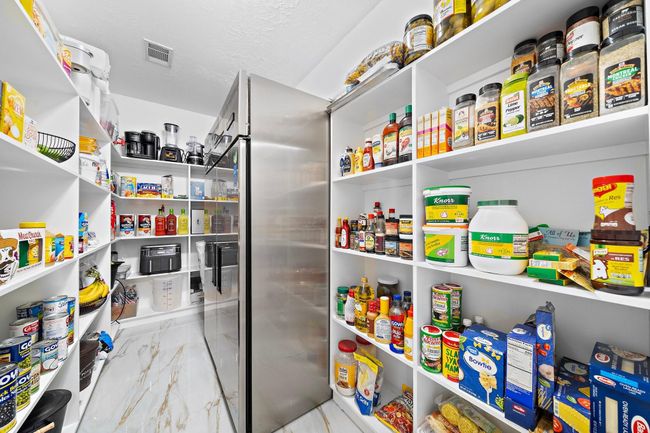 Walk-in pantry with ample shelving and storage space | Image 22