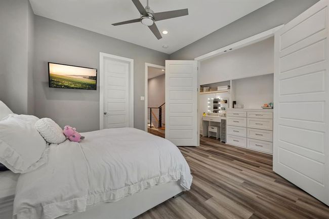 An expansive walk-in closet featuring a stylish vanity area, offering both functionality and elegance. | Image 40
