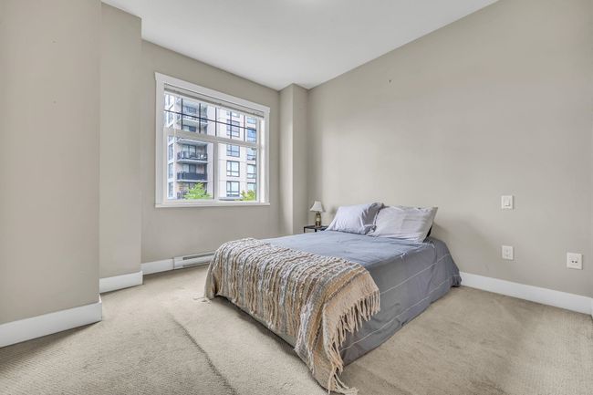Bedroom with light carpet, baseboards, and a baseboard radiator | Image 16