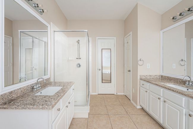 Full bath with two vanities, a stall shower, and tile patterned floors | Image 19