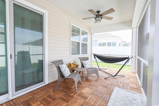 Sunroom / solarium with a ceiling fan | Image 25