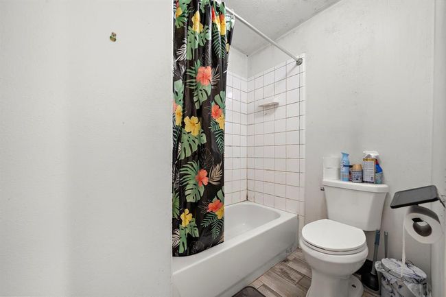This secondary bath combines practicality and comfort with a split layout, making it easy for two people to get ready at once. The tiled tub/shower combo and neutral tones create a blank slate for any future personal touches or updates. | Image 28