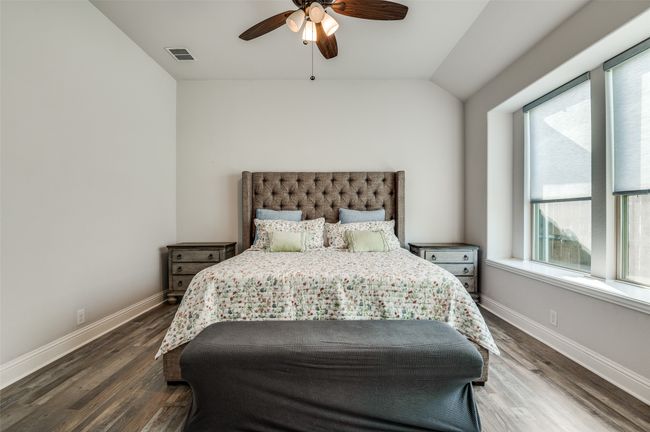 Bedroom featuring multiple windows, wood finished floors, and ceiling fan | Image 16