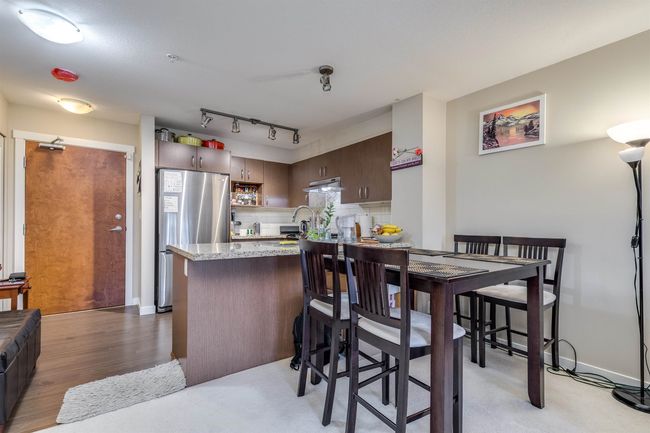 Dining space with light wood finished floors and baseboards | Image 7