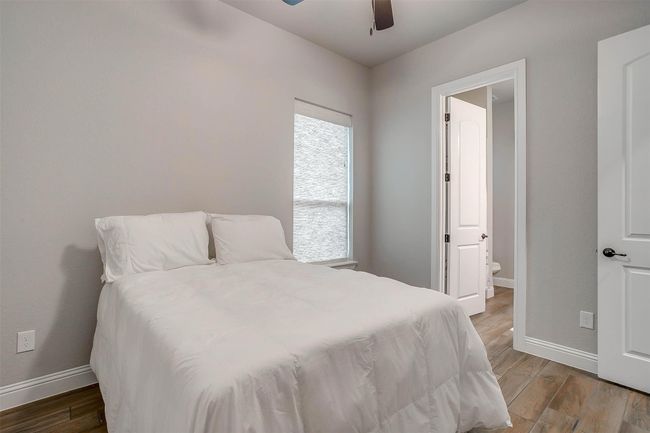 Bedroom featuring light wood-type flooring, ceiling fan, and ensuite bathroom | Image 21