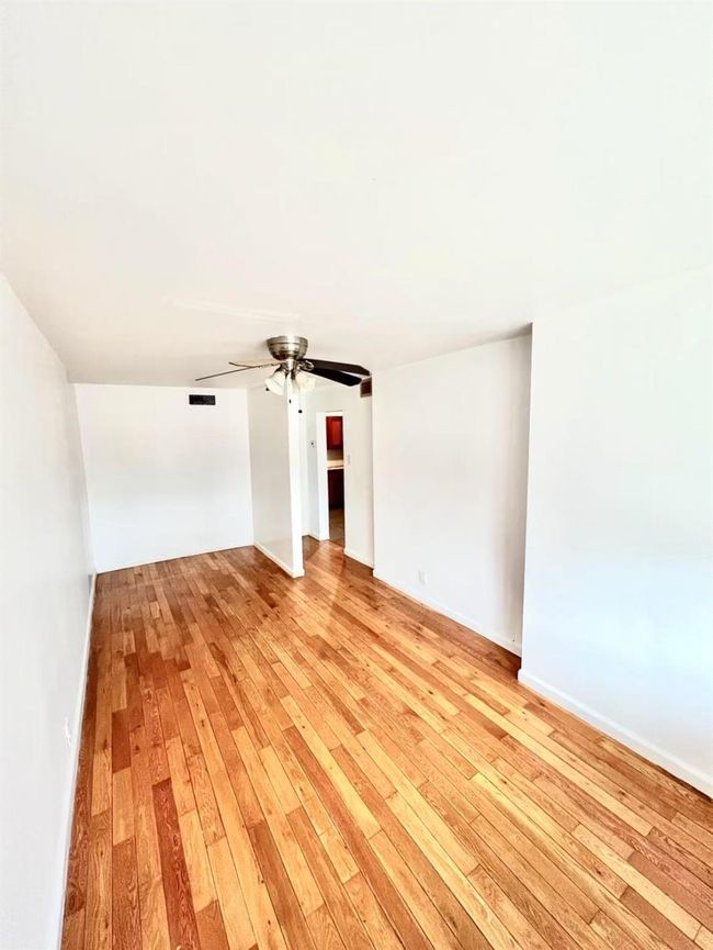 Empty room with ceiling fan and light hardwood / wood-style flooring | Image 4