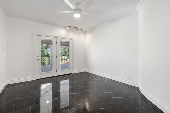 Empty room with french doors, baseboards, crown molding, and ceiling fan | Image 31