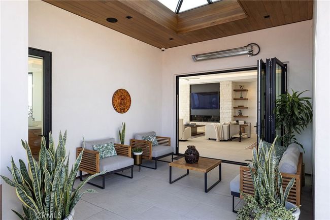 Off the kitchen or great room, you will find additional entertaining or relaxation space on your side patio with stunning skylight treatment, La Cantina door and built-in BBQ space. | Image 27