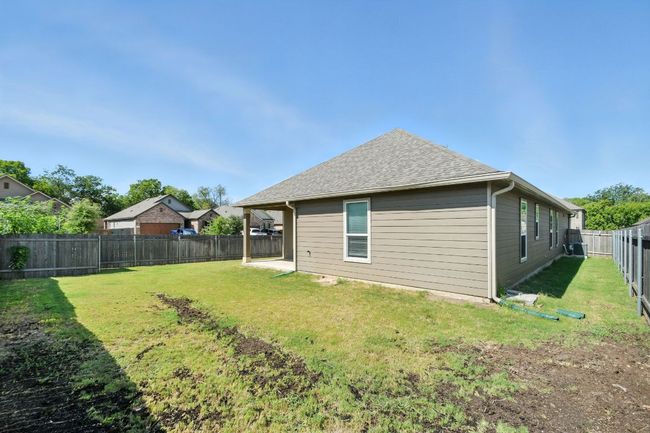 Back of house with a shingled roof, a patio area, and a fenced backyard | Image 30