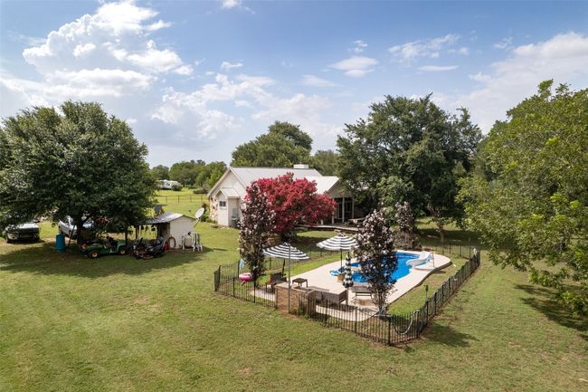 Fenced backyard with a patio and a shed | Image 37