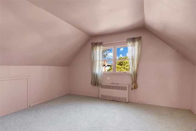 Bonus room featuring lofted ceiling, radiator, and carpet | Image 19