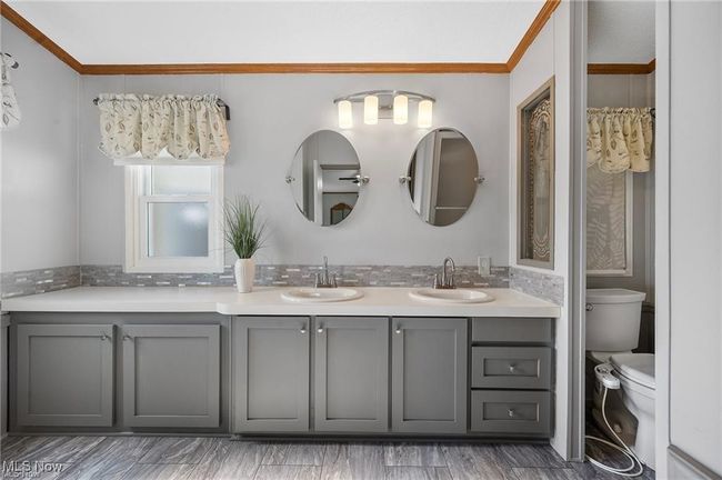 Full bathroom with double vanity and ornamental molding | Image 15