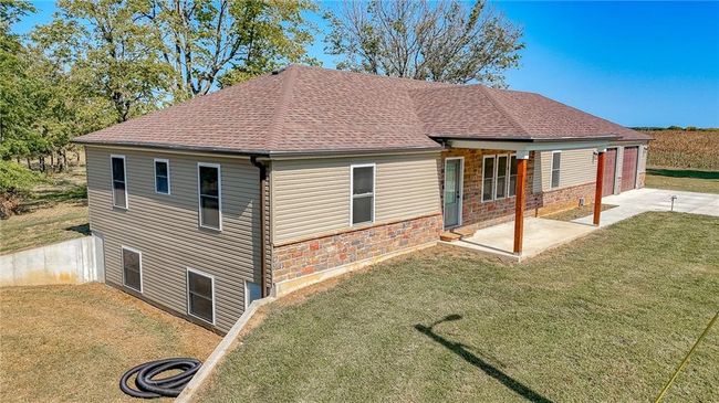 Rear view of house with a yard and a patio | Image 49