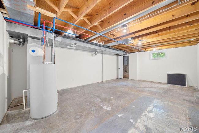 Below grade area featuring water heater | Image 43
