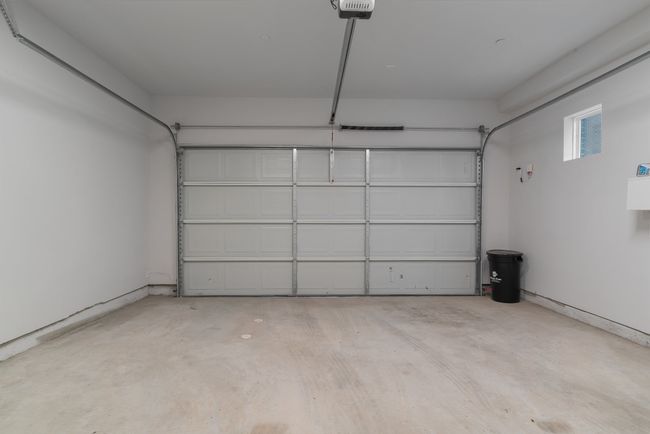 Garage with a garage door opener | Image 30