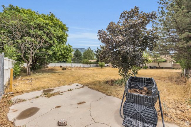 View of yard with a patio, fence, and a mountain view | Image 31