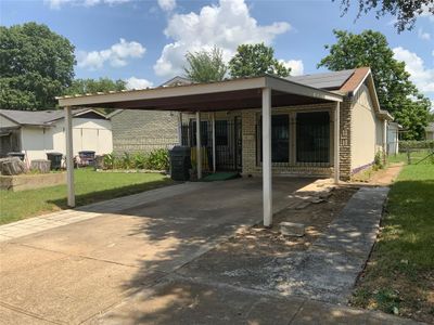 View of front facade with a carport, solar panels, and a front lawn | Image 2