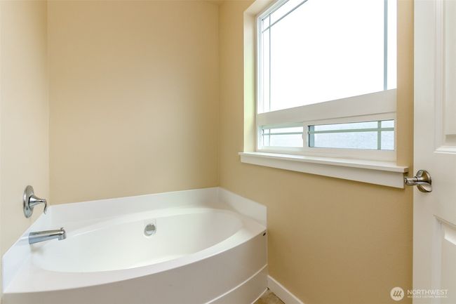 Luxurious soaking tub in the primary bathroom. | Image 21