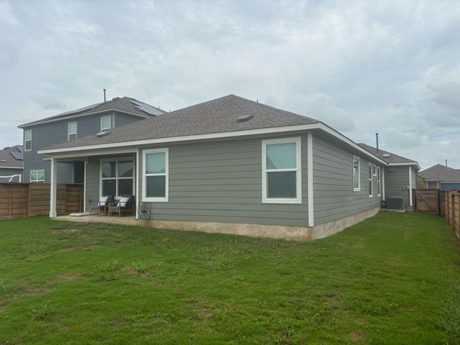 Back of house with a fenced backyard, a patio area, and roof with shingles | Image 4