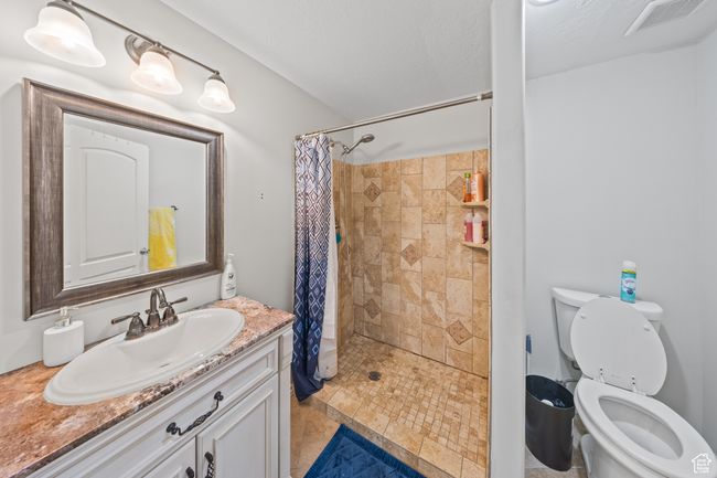 Bathroom featuring vanity and a tile shower | Image 23
