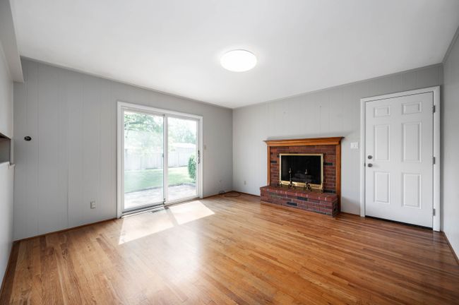 Original hardwood floors, fireplace, and slider to backyard | Image 9