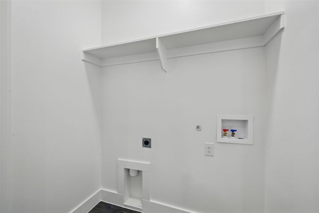 Washroom with dark wood-type flooring, baseboards, electric dryer hookup, laundry area, and washer hookup | Image 12