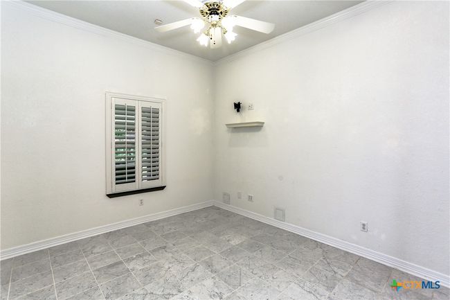 Second bedroom downstairs with wooden shutters on windows | Image 24