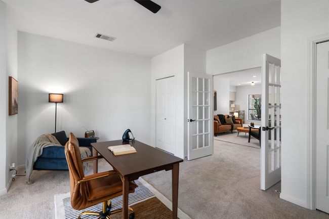 Office area featuring visible vents, french doors, baseboards, light colored carpet, and ceiling fan | Image 10